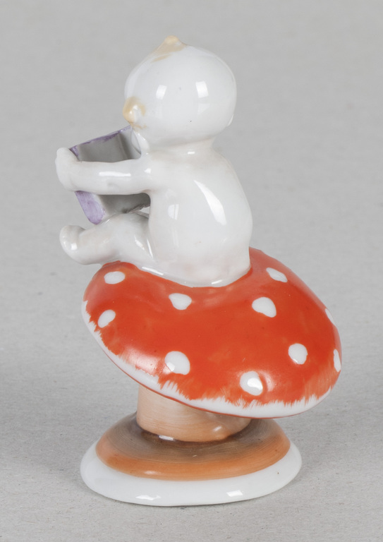Porcelain figure „Boy with a book on fly-agaric”