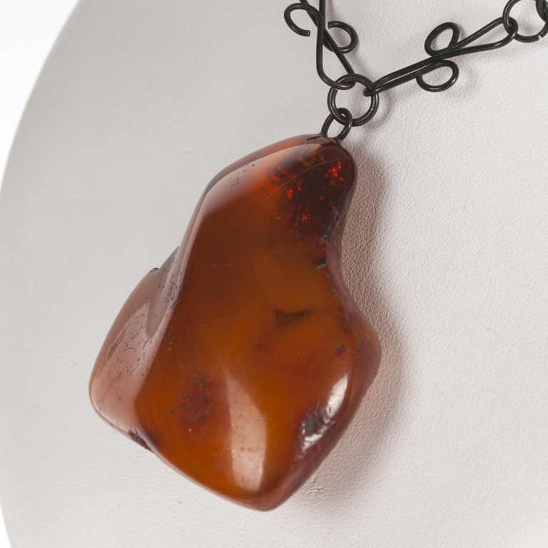 Metal necklace with amber pendant