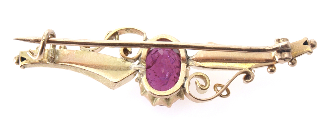 Gold brooch with purple stone