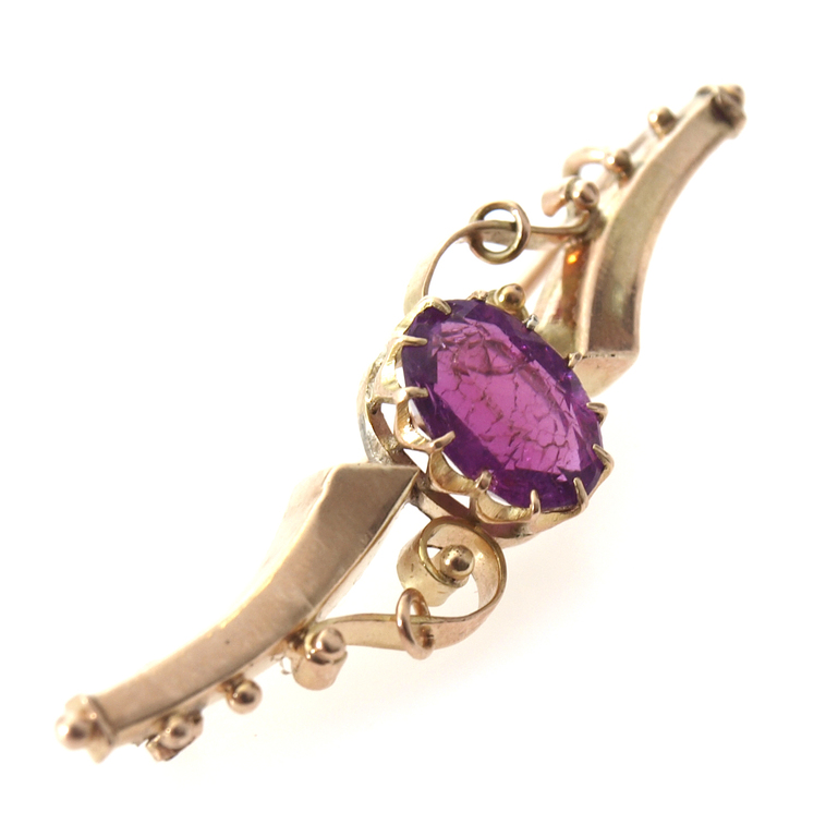 Gold brooch with purple stone