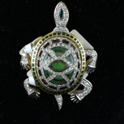 Gold brooch with diamonds and emeralds