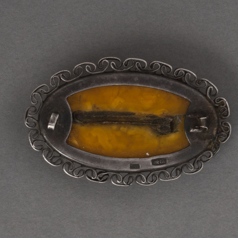 Amber brooch with silver finish 