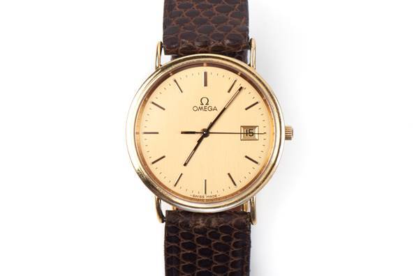 Gold wristwatch with varanus skin strap Omega