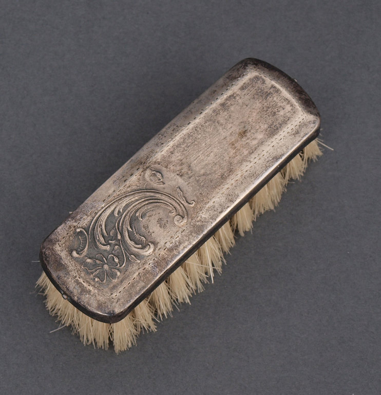 Clothing brush in silver frame