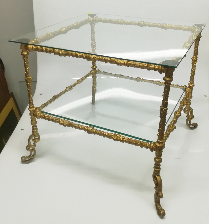 Glass table with bronzed metal finish
