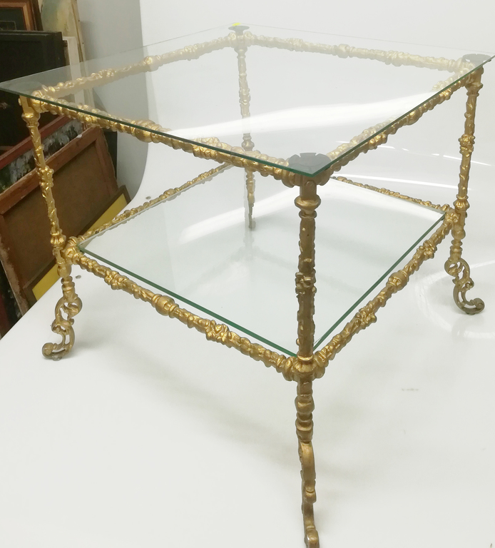 Glass table with bronzed metal finish
