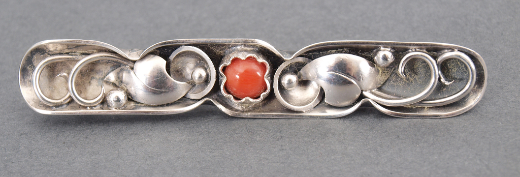 Silver brooch with red coral
