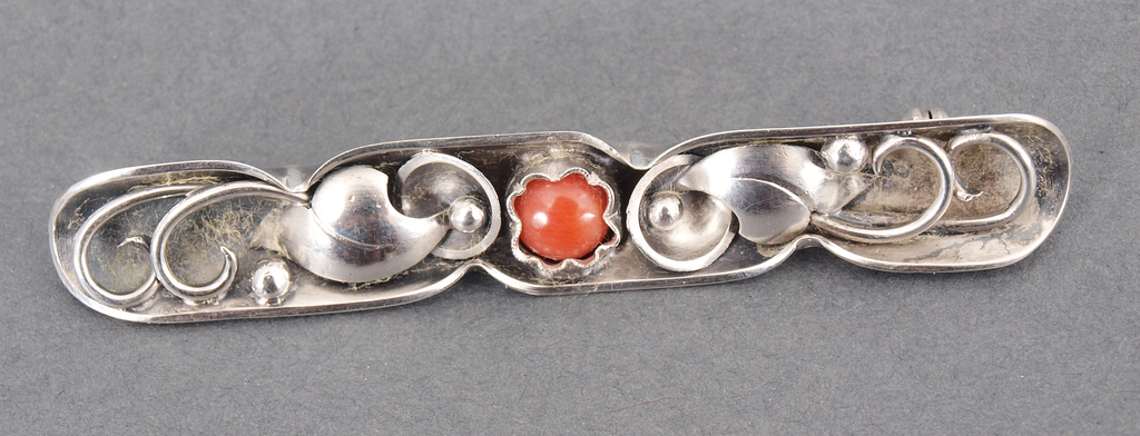 Silver brooch with red coral