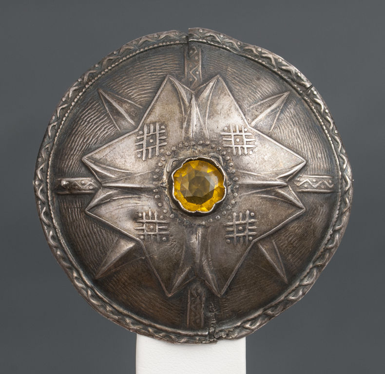 Silver brooch with yellow stone
