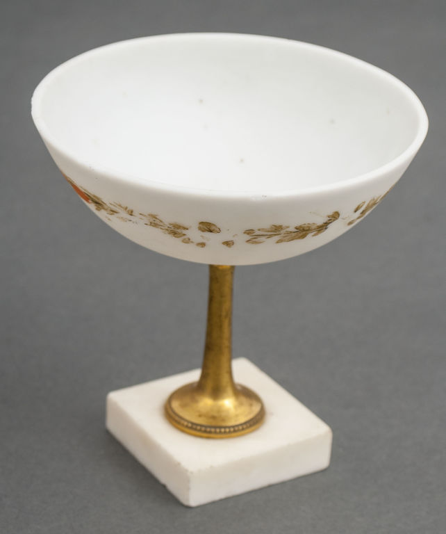 Opal glass serving utensil on the marble base