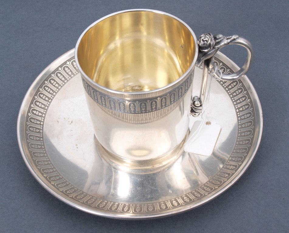 Silver cup with saucer 