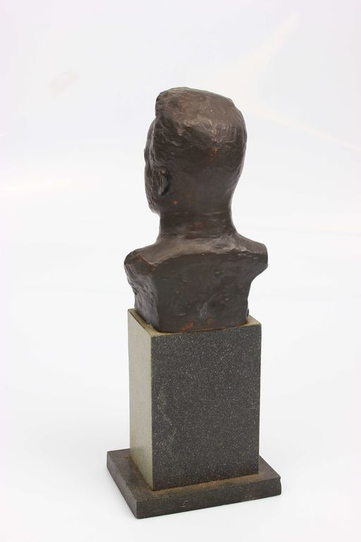 Metal bust on the base of the stone 