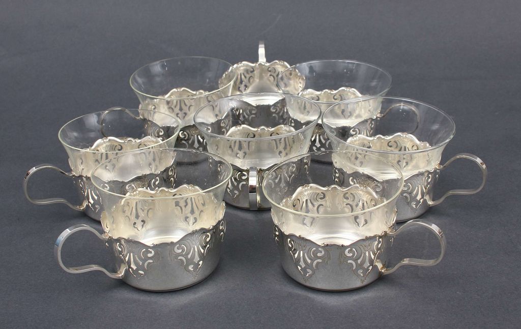 Silver glass holders (8 pcs.) and 7 glasses