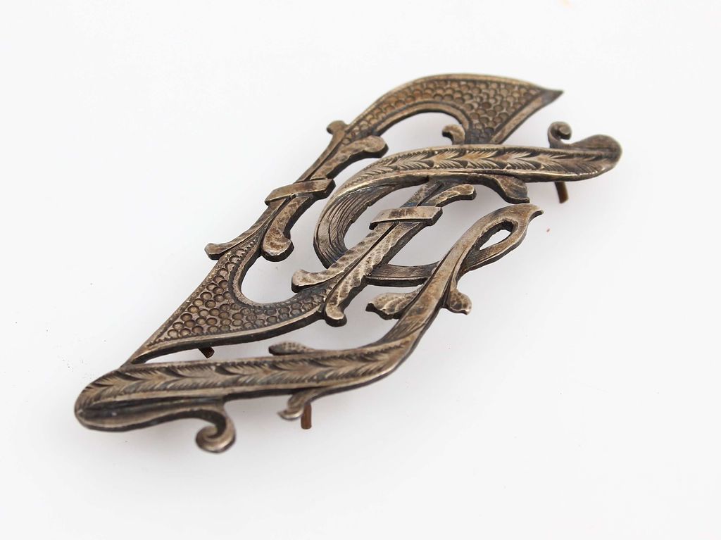 Silver brooch for the album