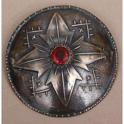 Silver brooch with red stone