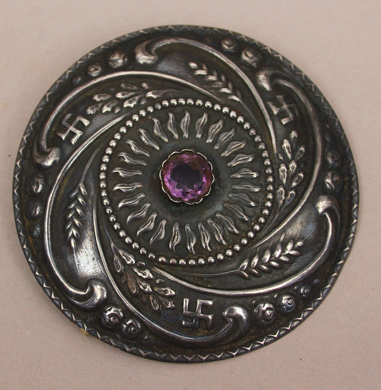 Silver brooch with purple stone