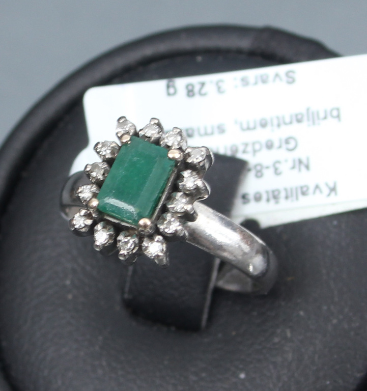 Platinum ring with diamonds and emerald