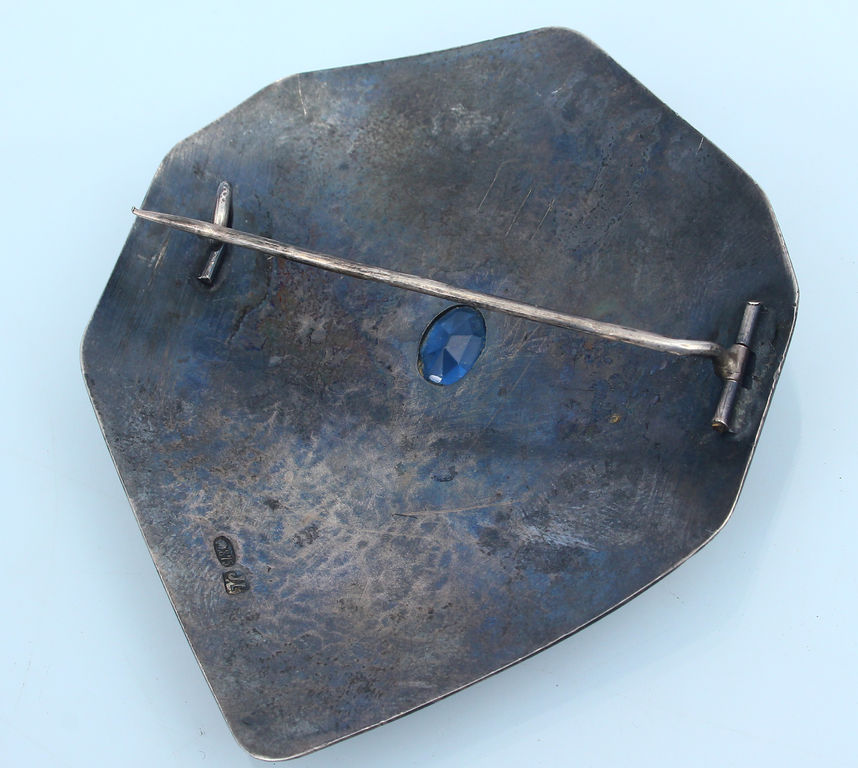 Silver brooch with blue stone 
