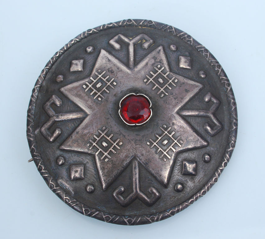 Silver brooch with red stone 
