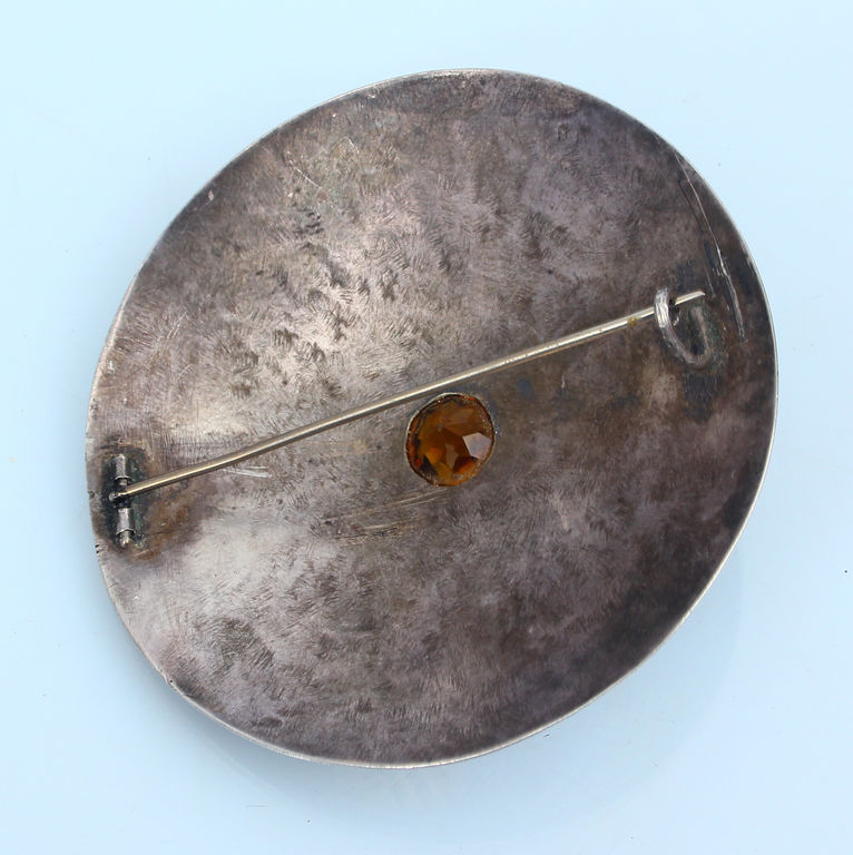 Silver brooch with orange stone 