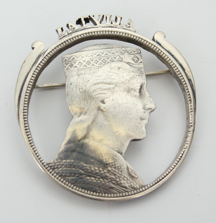 Silver brooch from a five lats coin 
