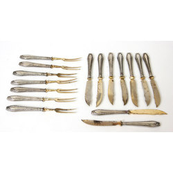 Set of silver dessert forks and knives with gilding