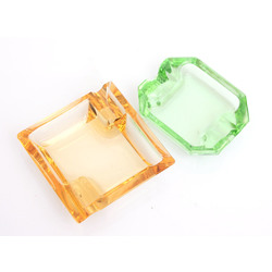 Two colored glass ashtrays