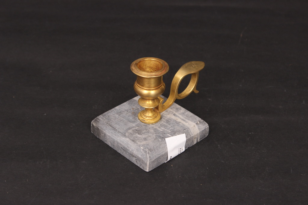 Bronze candlestick on a marble base
