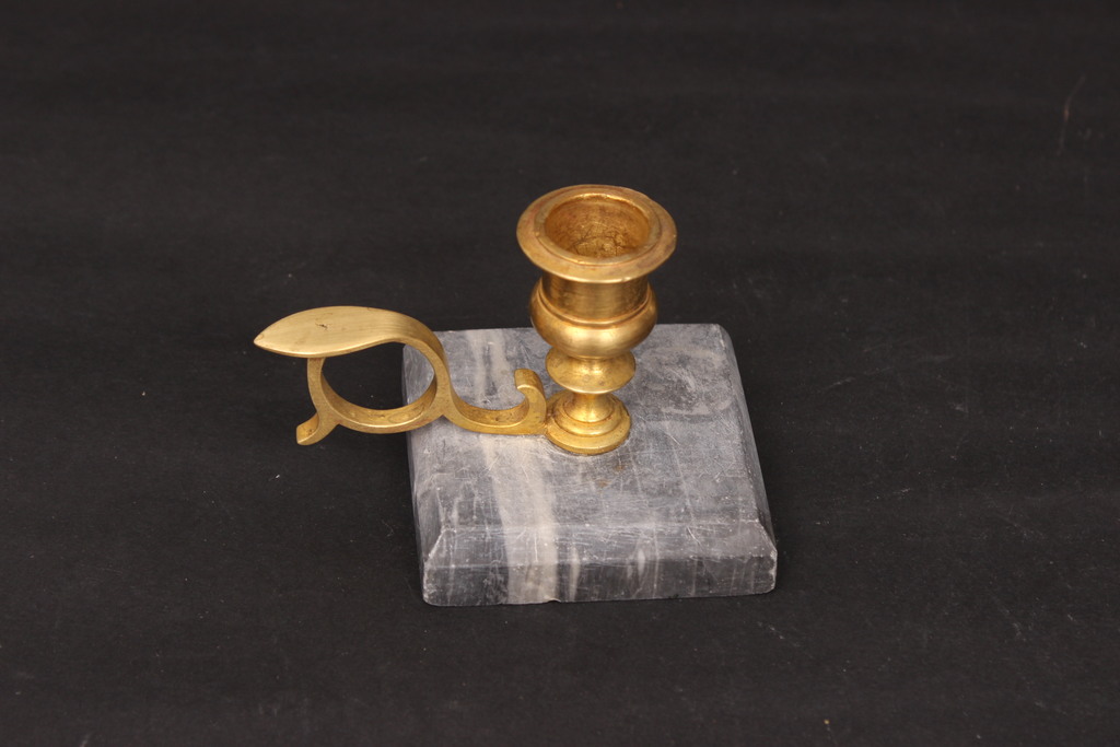Bronze candlestick on a marble base