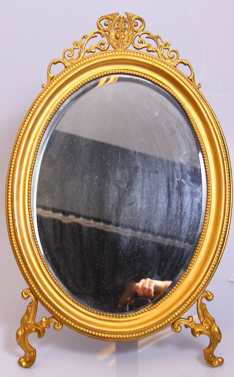 Oval mirror in a metal frame