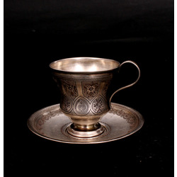 Silver cup with saucer