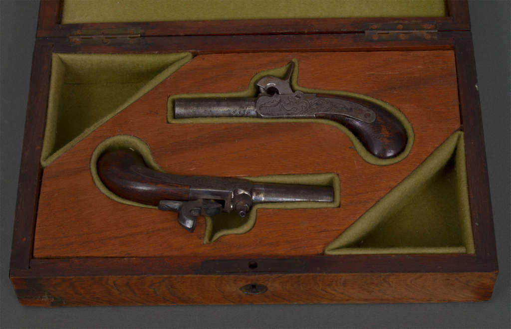 A pair of mini pocket pistols, original box