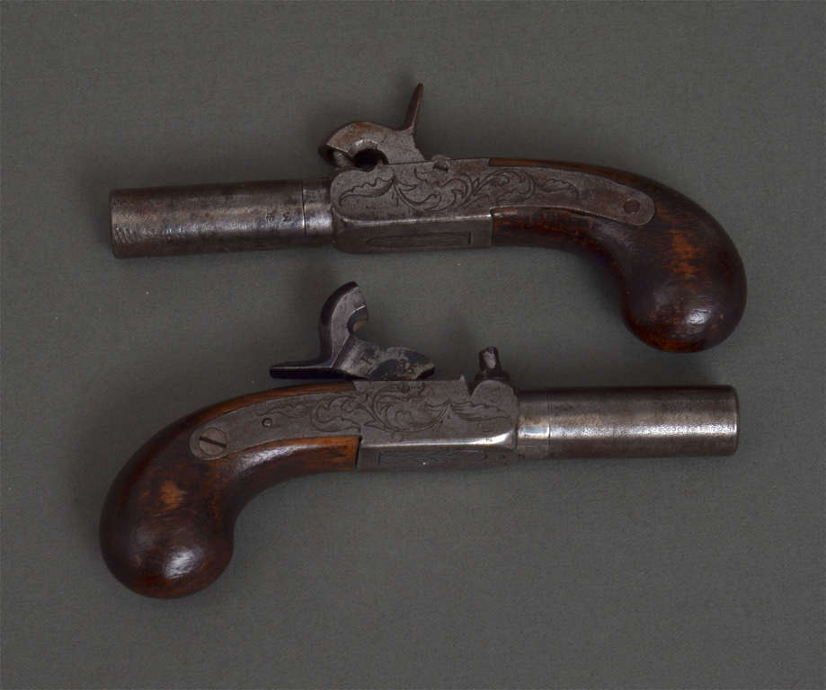 A pair of mini pocket pistols, original box