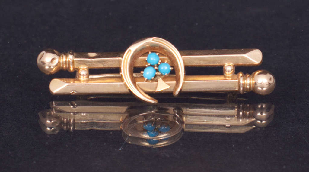 56th proof gold brooch with turquoise
