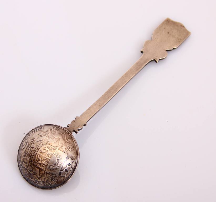 Silver spoon with Riga coat of arms and five-lats coin