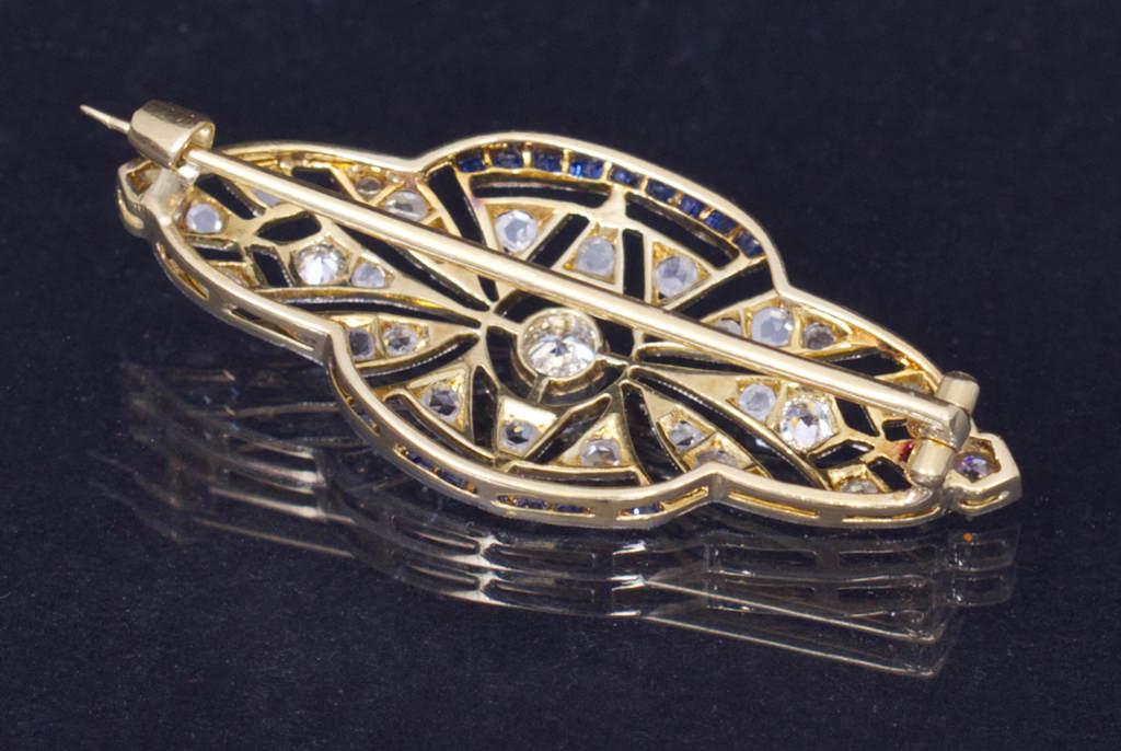 Art deco style gold brooch with diamonds and sapphires