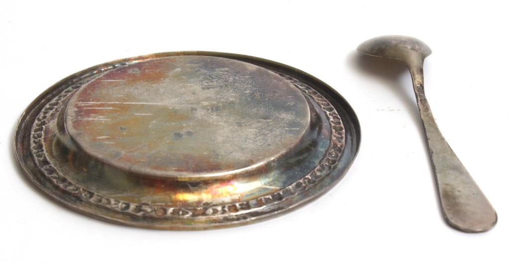A small silver plate with a spoon