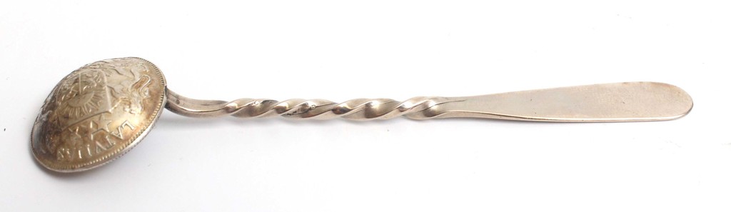 The silver spoon is made of a Latvian two lats coin