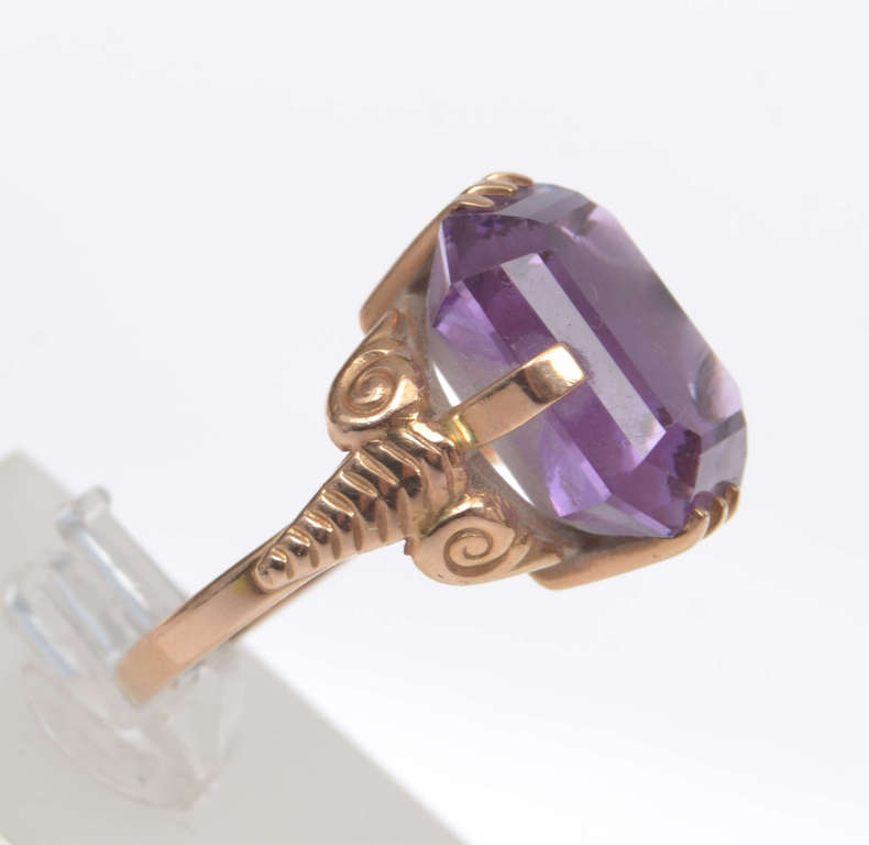 Gold ring with a purple stone