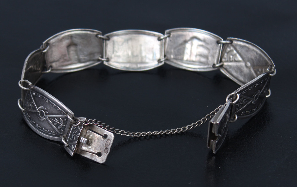 Silver bracelet with various objects in Riga