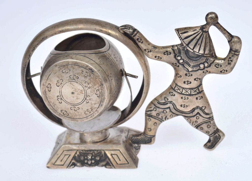 Silver figurine with a sieve for making tea