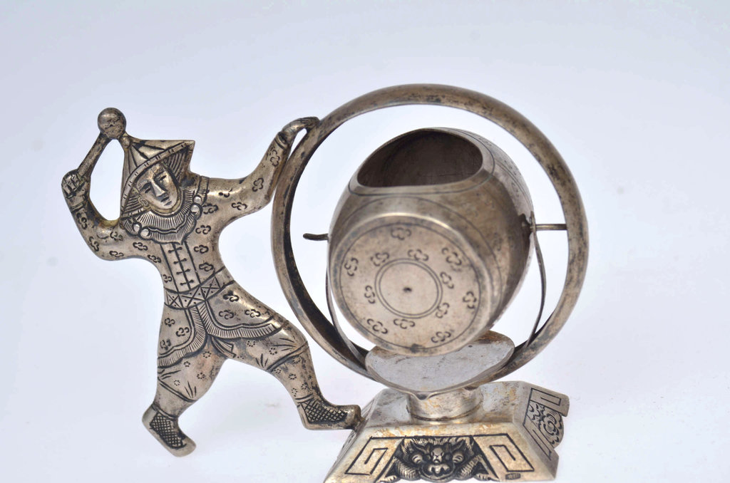 Silver figurine with a sieve for making tea