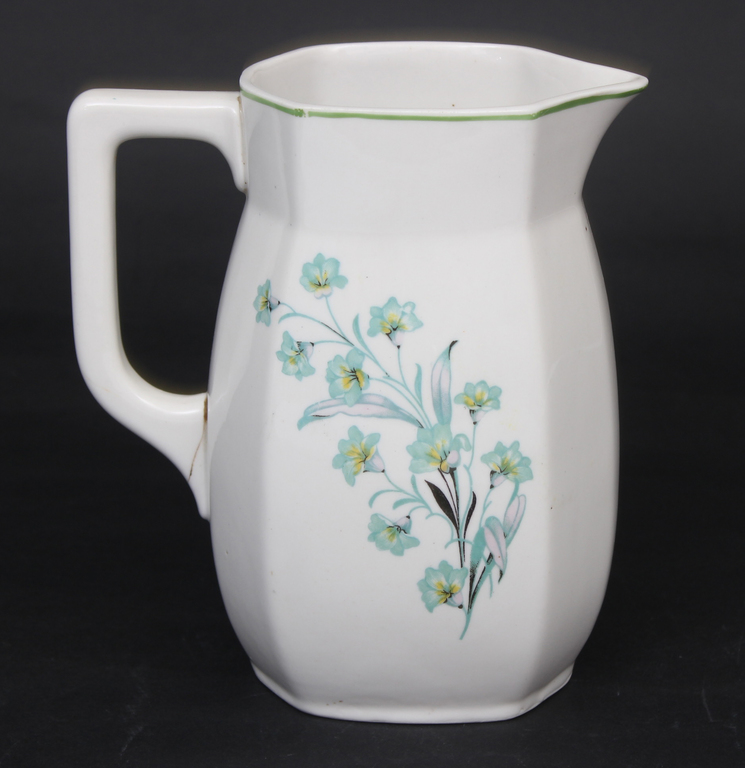 Porcelain pitcher with a crack in the handle