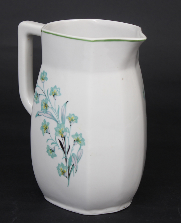 Porcelain pitcher with a crack in the handle