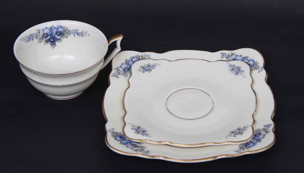Porcelain cup with the saucer and plate