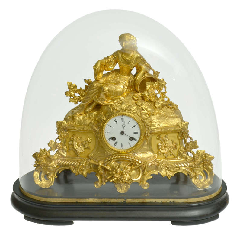 Fireplace clock on a wooden base with a glass dome