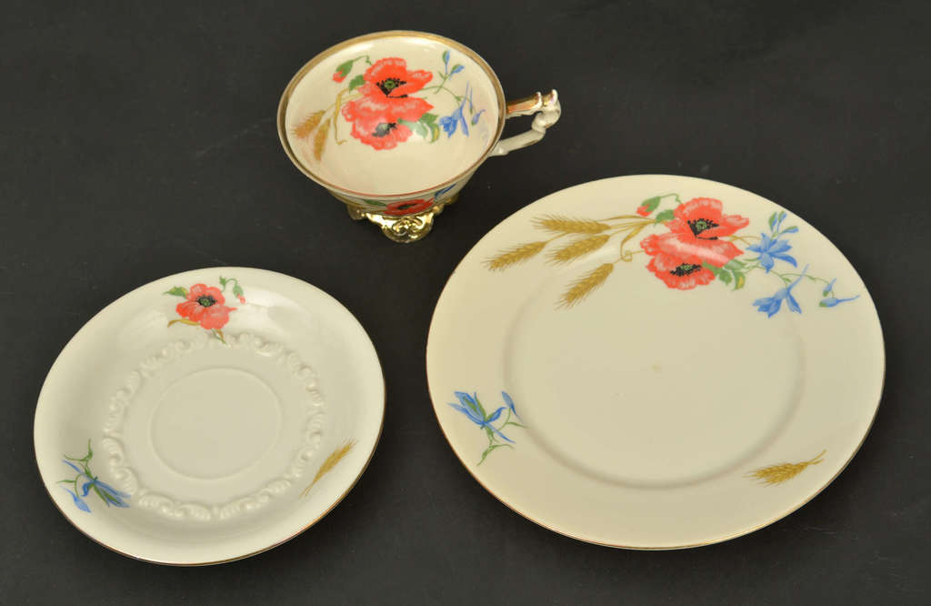 Porcelain cup and two saucers with poppies