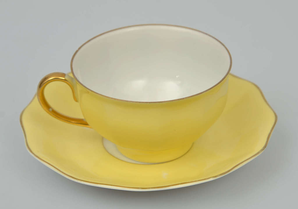 Yellow porcelain cup with saucer