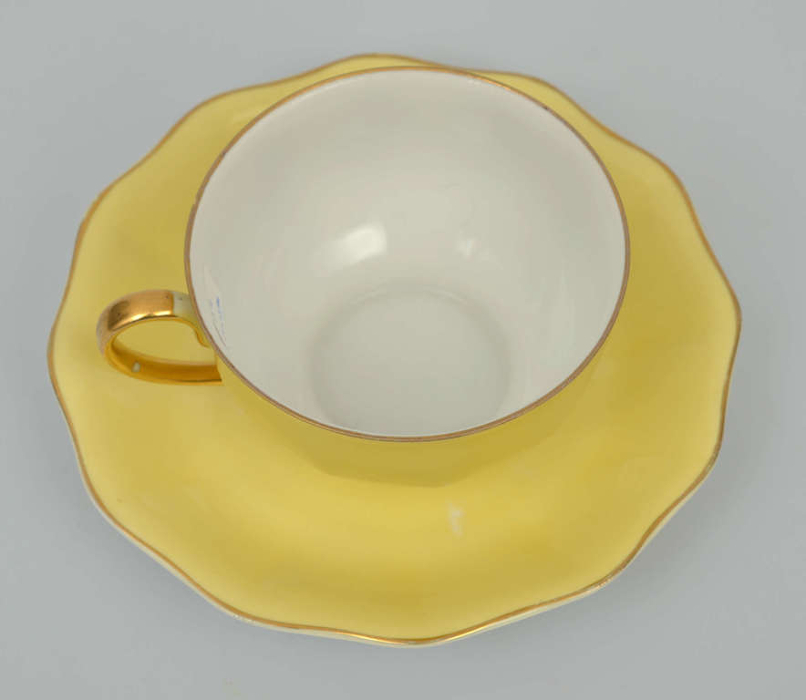 Yellow porcelain cup with saucer
