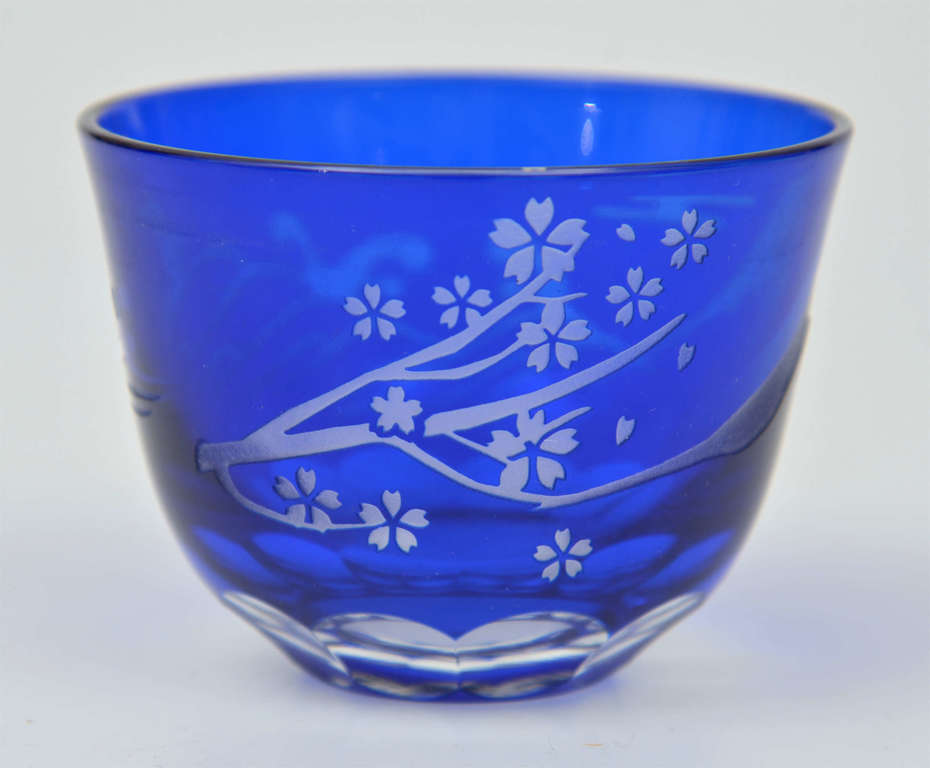Blue glass cup with fragments of nature